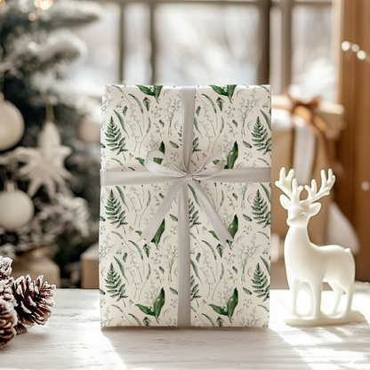 a present wrapped in white paper with a deer figurine next to it