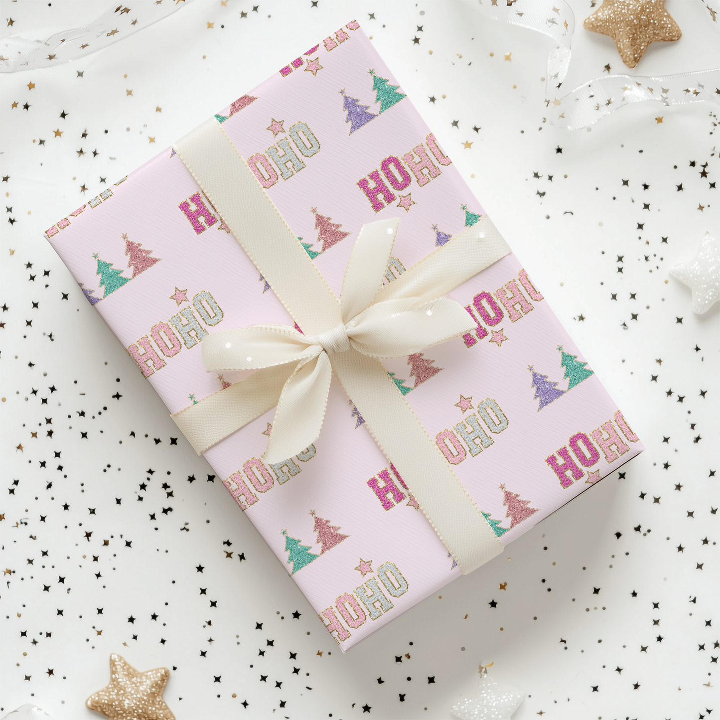 a present wrapped in pink wrapping paper with a bow