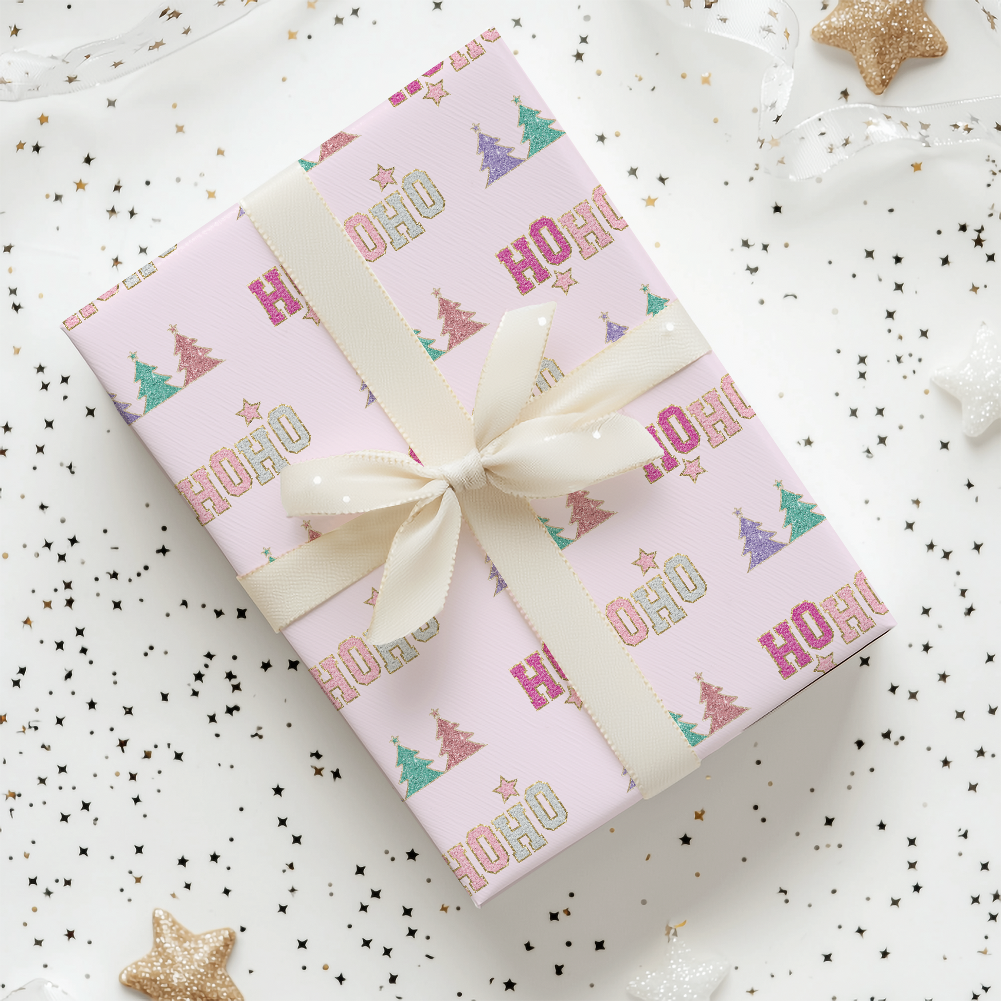 a present wrapped in pink wrapping paper with a bow
