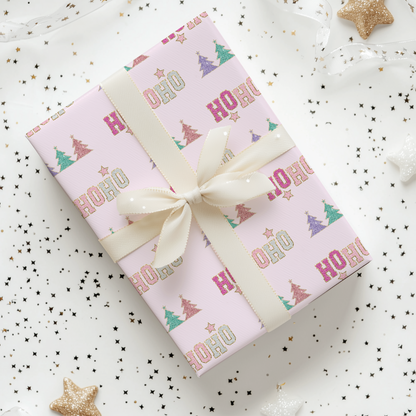 a present wrapped in pink wrapping paper with a bow