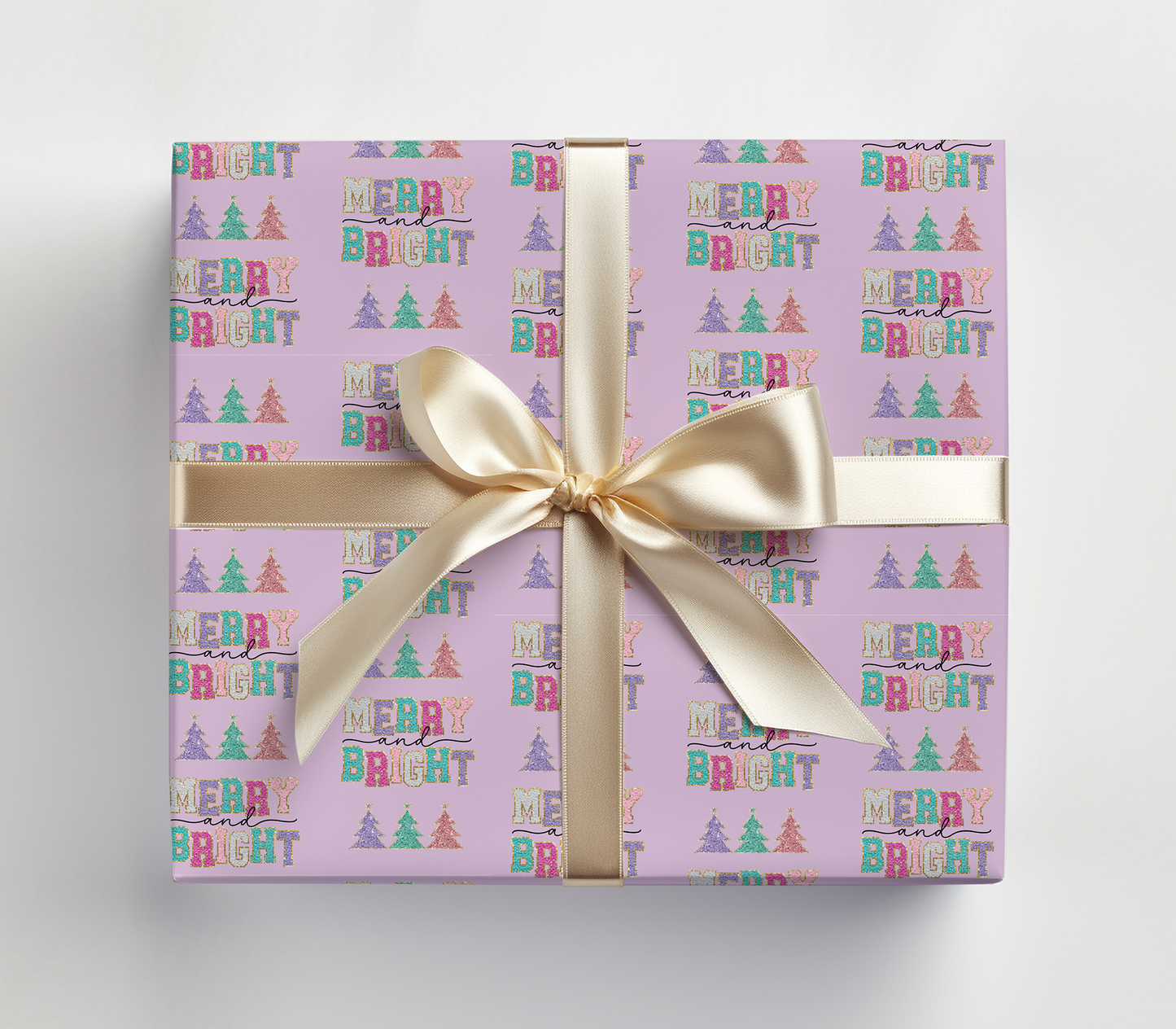 a purple gift box with a gold ribbon and a bow