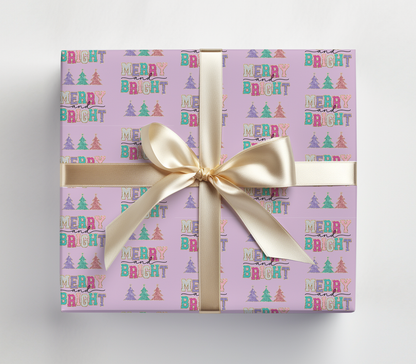 a purple gift box with a gold ribbon and a bow