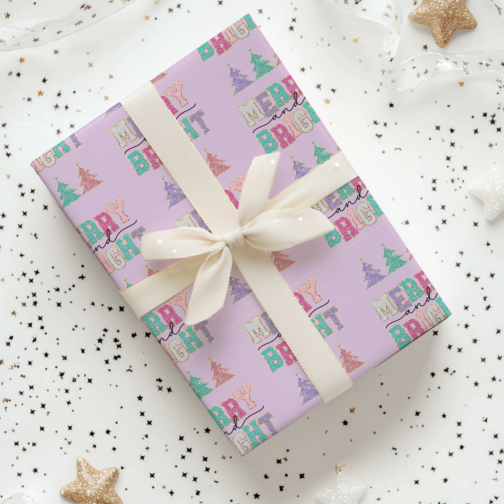 a gift wrapped in a pink wrapping paper with a white ribbon