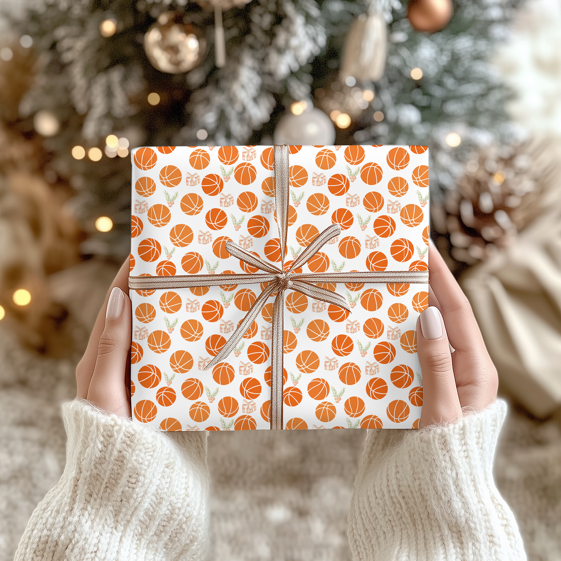 a person holding a wrapped present in front of a christmas tree