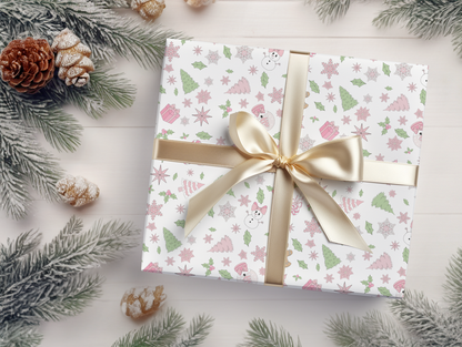 a present wrapped in white paper with a gold ribbon