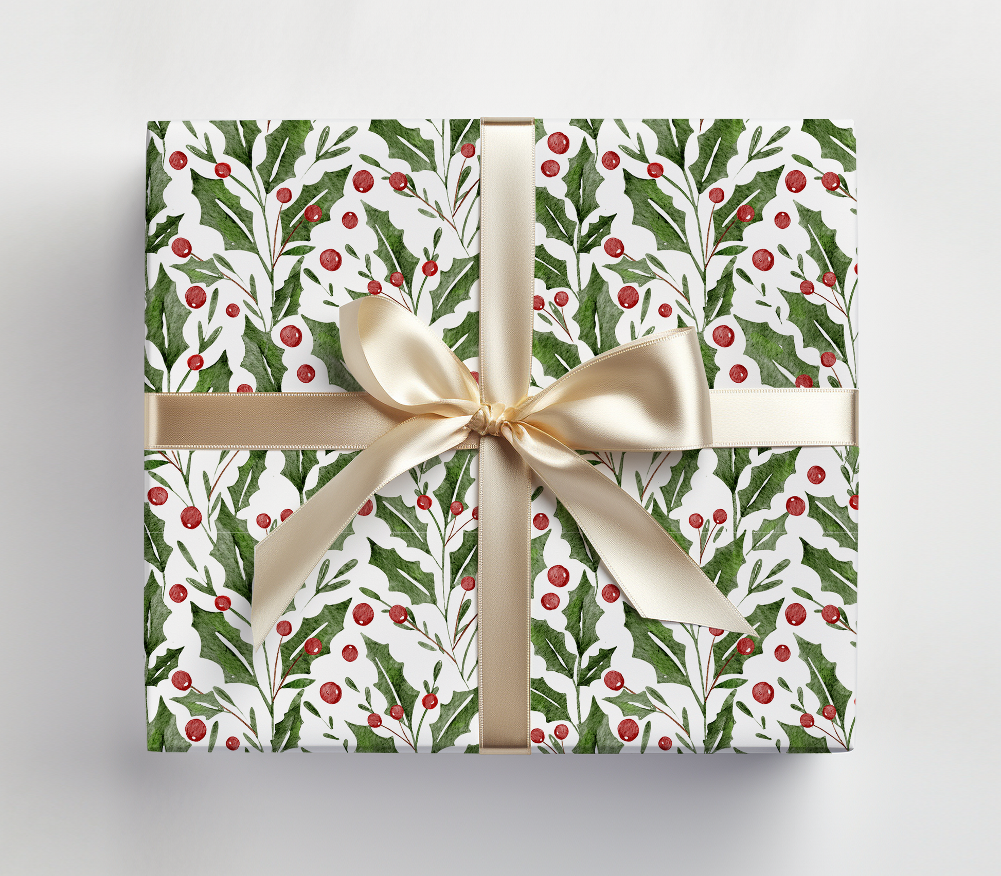 a present wrapped in a white wrapping paper with a gold bow