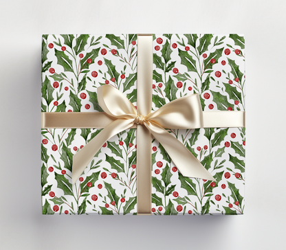 a present wrapped in a white wrapping paper with a gold bow