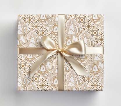 a wrapped gift box with a gold bow