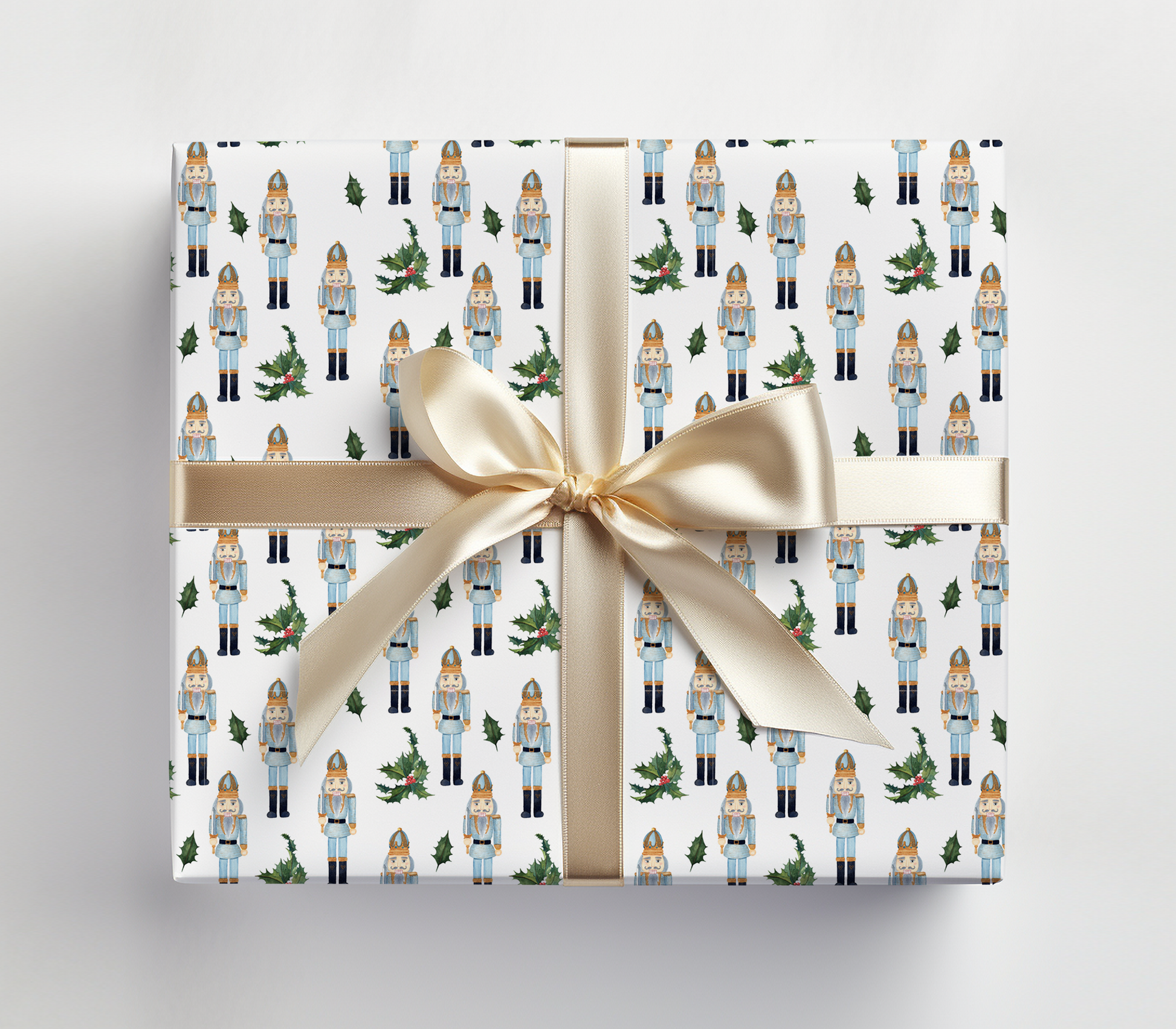 a present wrapped in a white wrapping paper with a gold ribbon