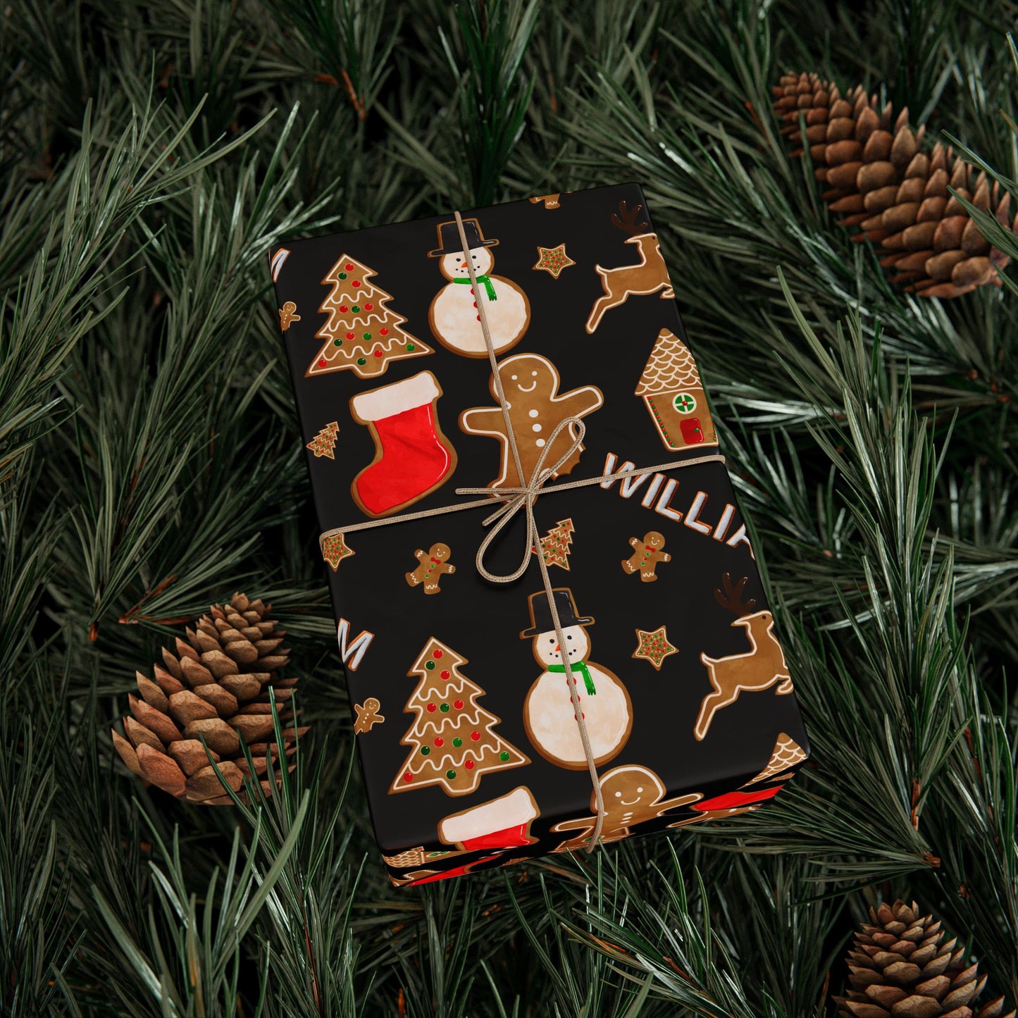 a christmas present wrapped in a black wrapping paper surrounded by pine cones