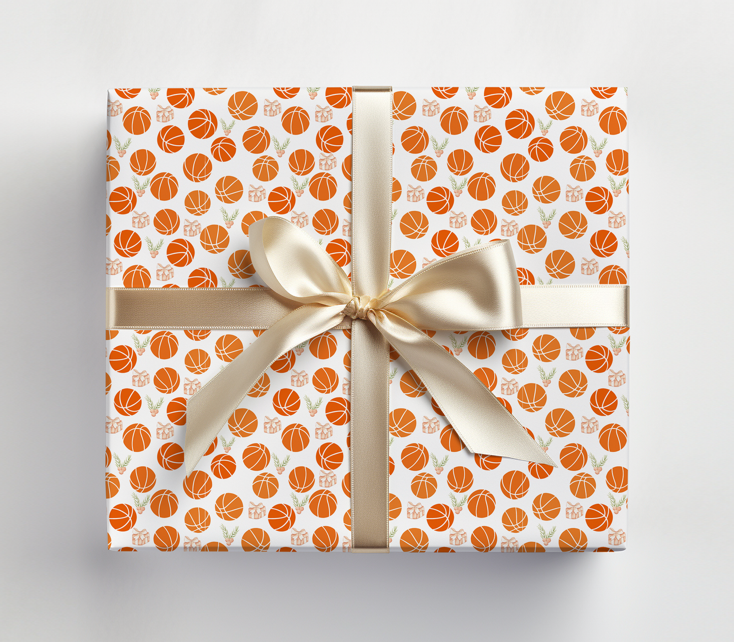a wrapped gift box with a bow and basketballs on it