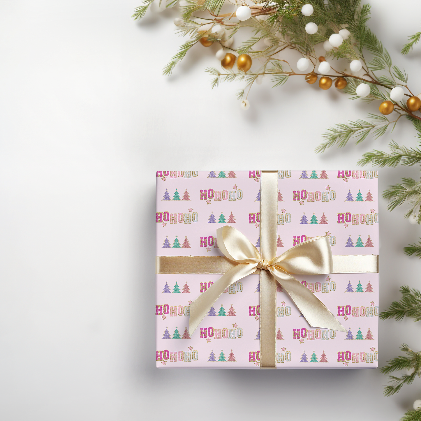 a present wrapped in pink paper with a gold bow