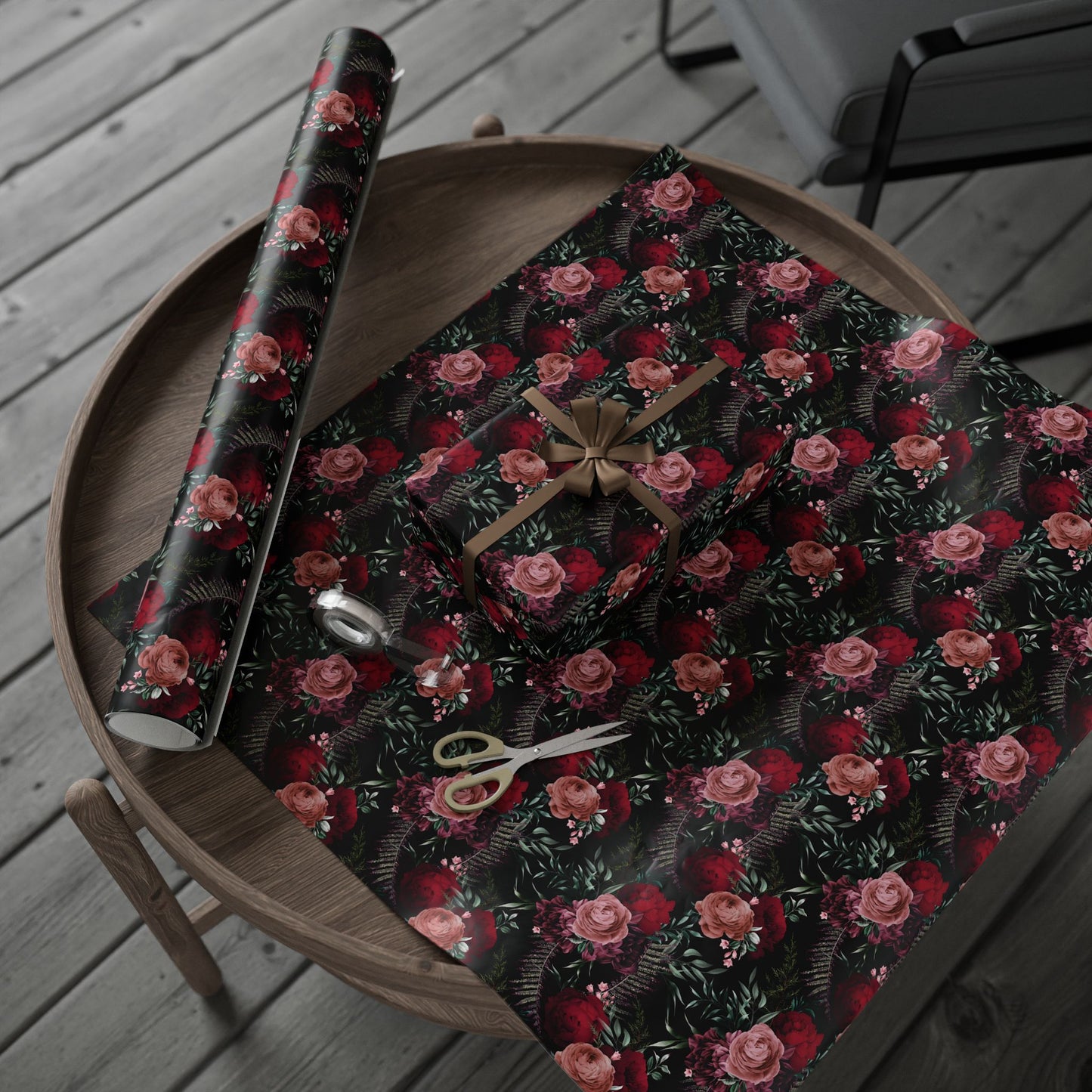 a table topped with a wrapping paper and a pair of scissors