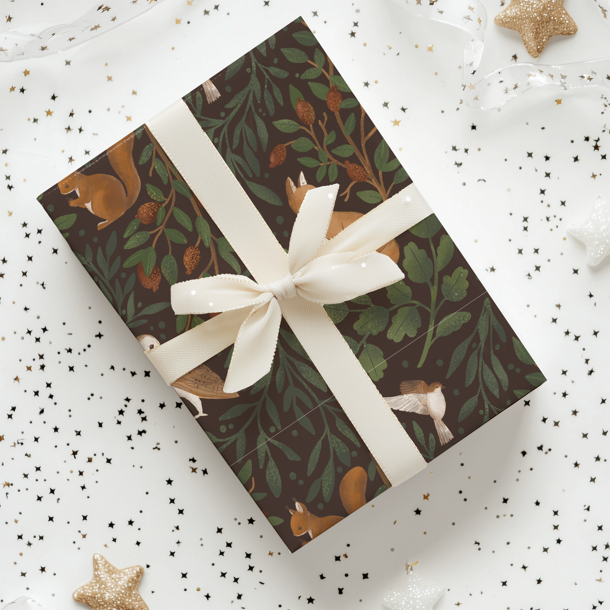 a gift wrapped in a brown and white wrapping paper with a white ribbon