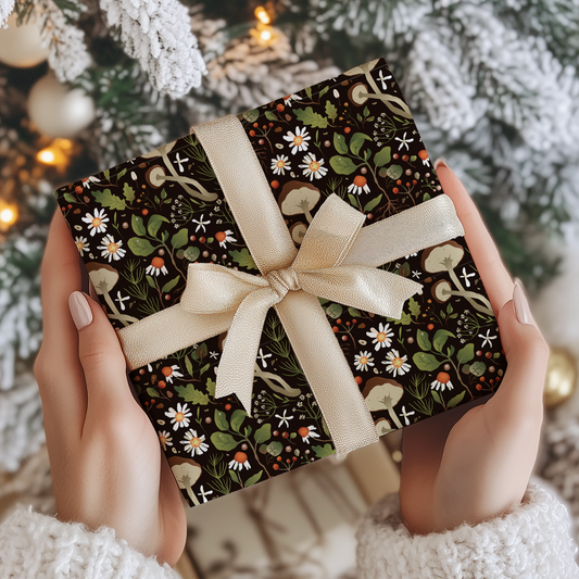 a person holding a present in front of a christmas tree