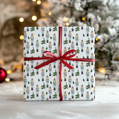a present wrapped in white paper with a red ribbon