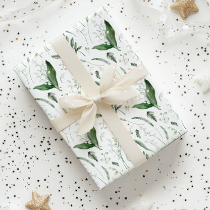 a present wrapped in a white wrapping paper with a bow