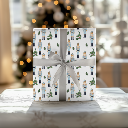 a present wrapped in white paper with a christmas tree in the background