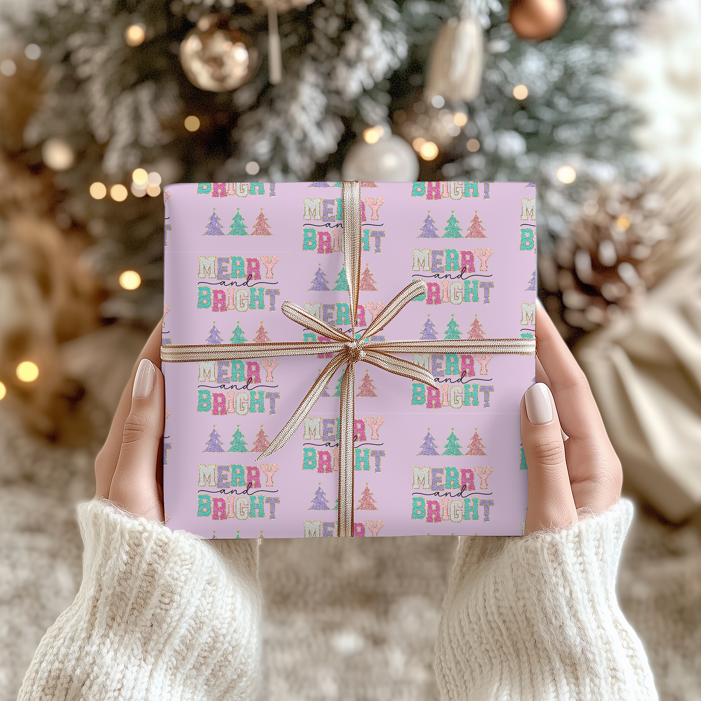 a woman holding a pink birthday present in front of a christmas tree