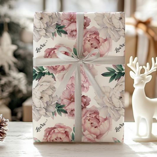 a gift wrapped in a floral paper with a bow