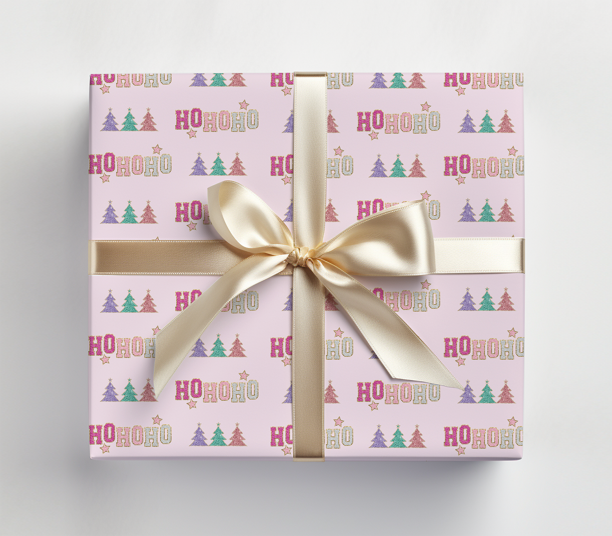 a pink gift box with a gold ribbon and a bow