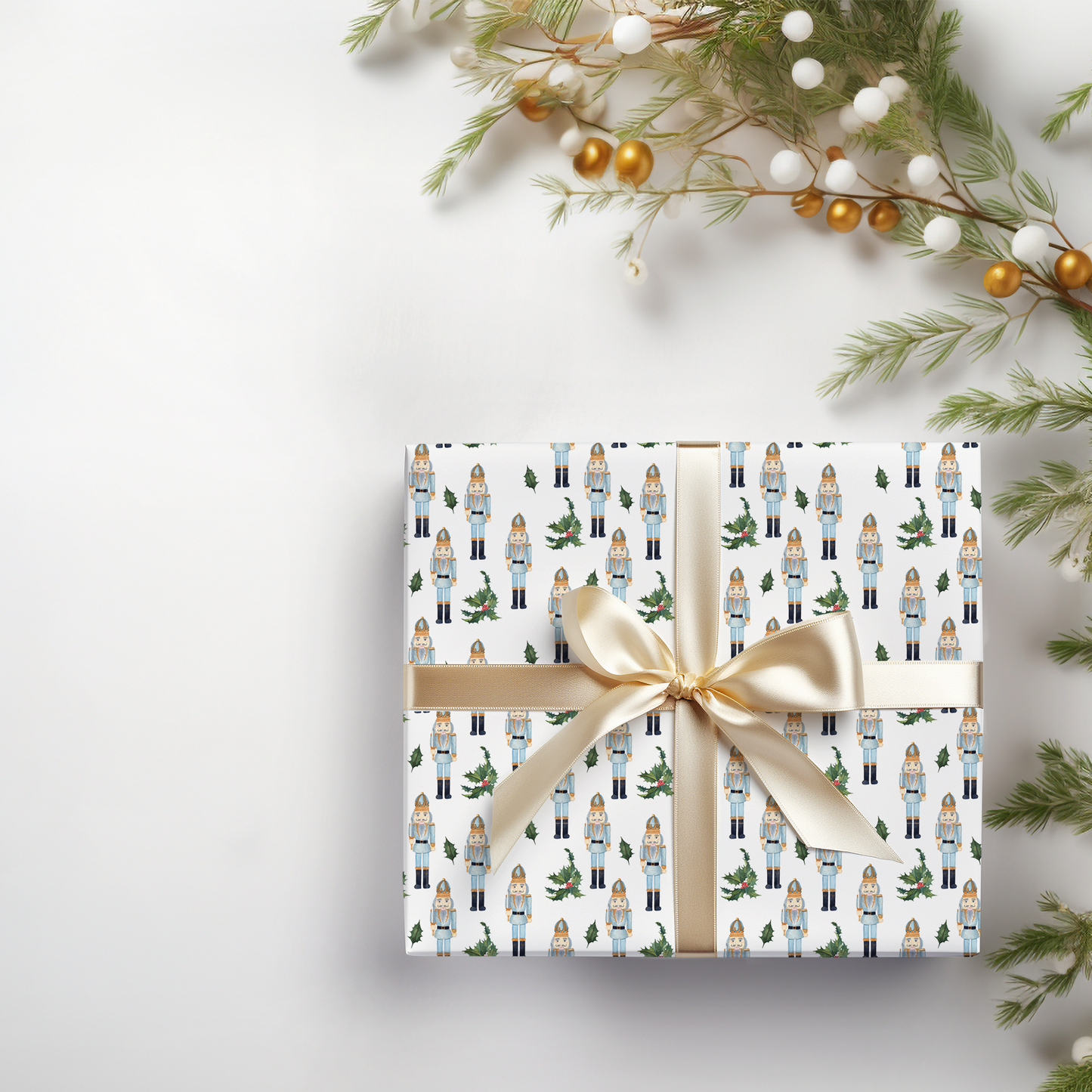 a present wrapped in white paper with a gold bow