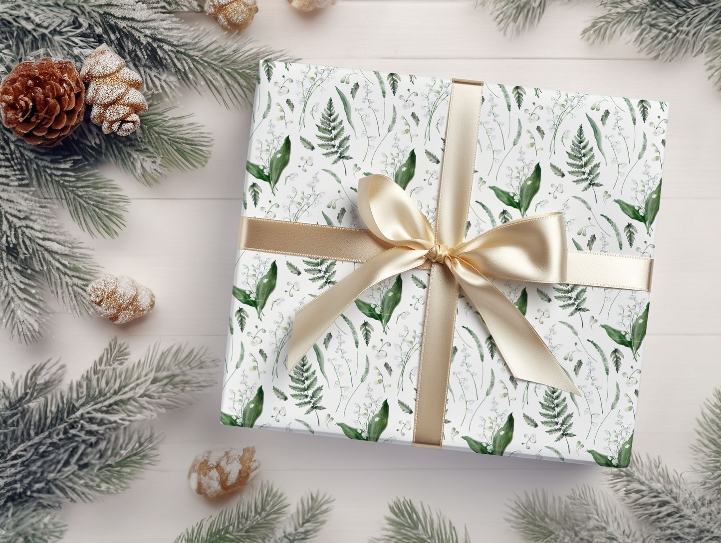 a present wrapped in white paper with a gold bow