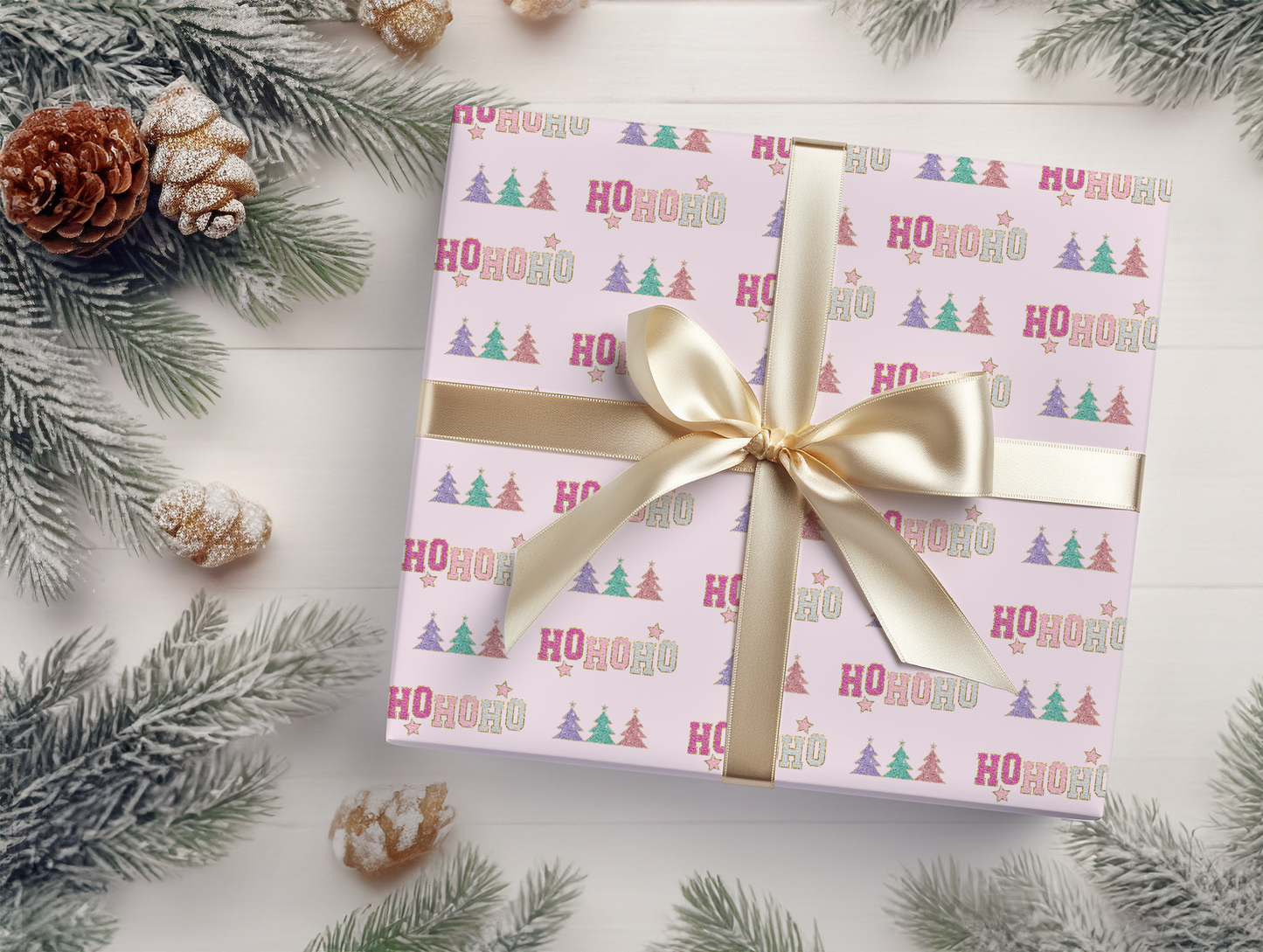 a present wrapped in a pink wrapping paper with a gold bow