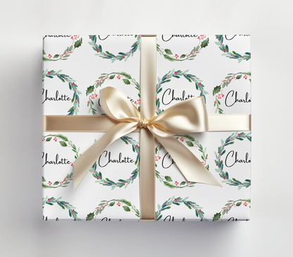 a gift wrapped in a white wrapping paper with a gold bow