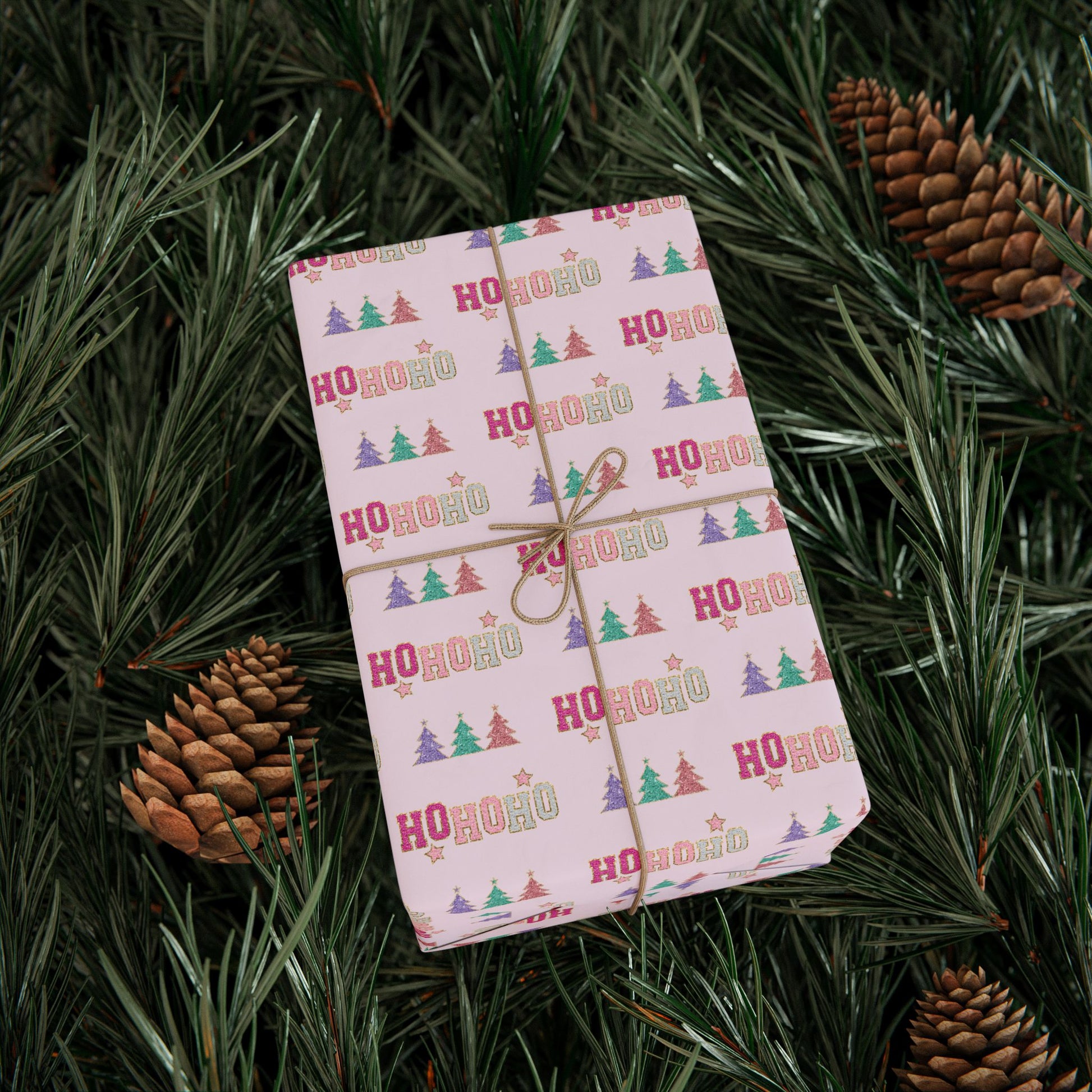 a wrapped present sitting on top of a pine tree