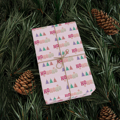 a wrapped present sitting on top of a pine tree