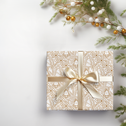 a gift wrapped in a white paper with a gold bow