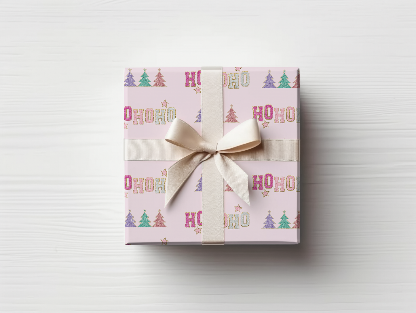 a gift wrapped in pink wrapping paper with a bow
