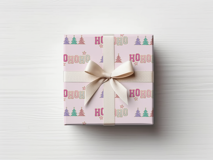 a gift wrapped in pink wrapping paper with a bow