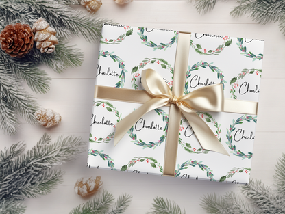 a gift wrapped in white paper with a gold ribbon