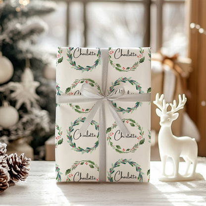 a christmas present wrapped in white paper with a bow
