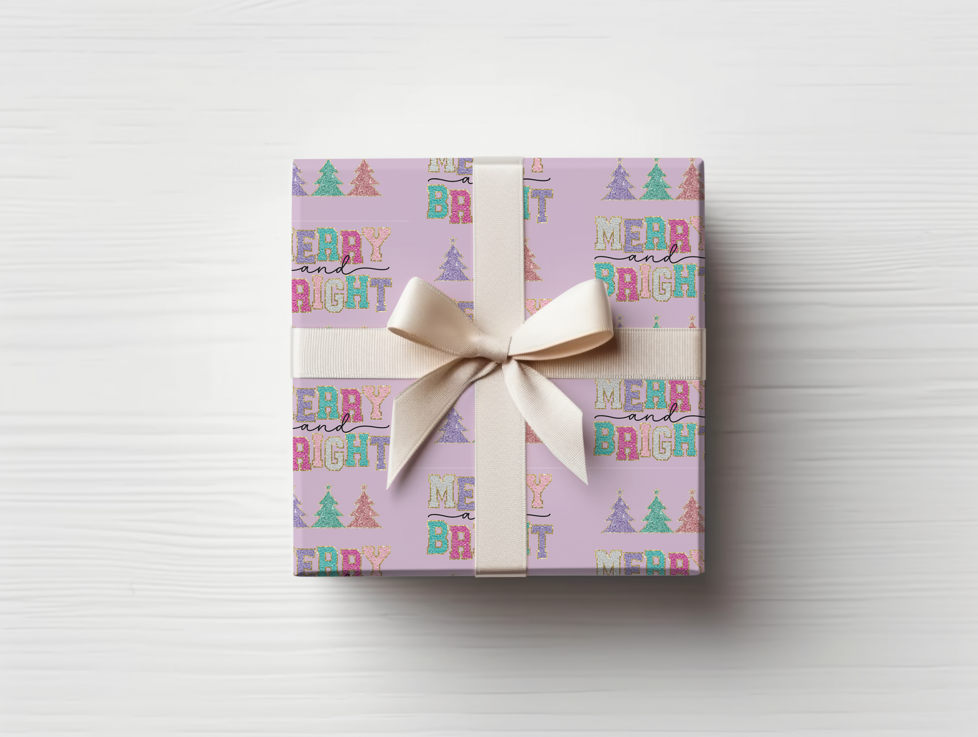 a gift wrapped in a pink wrapping paper with a bow