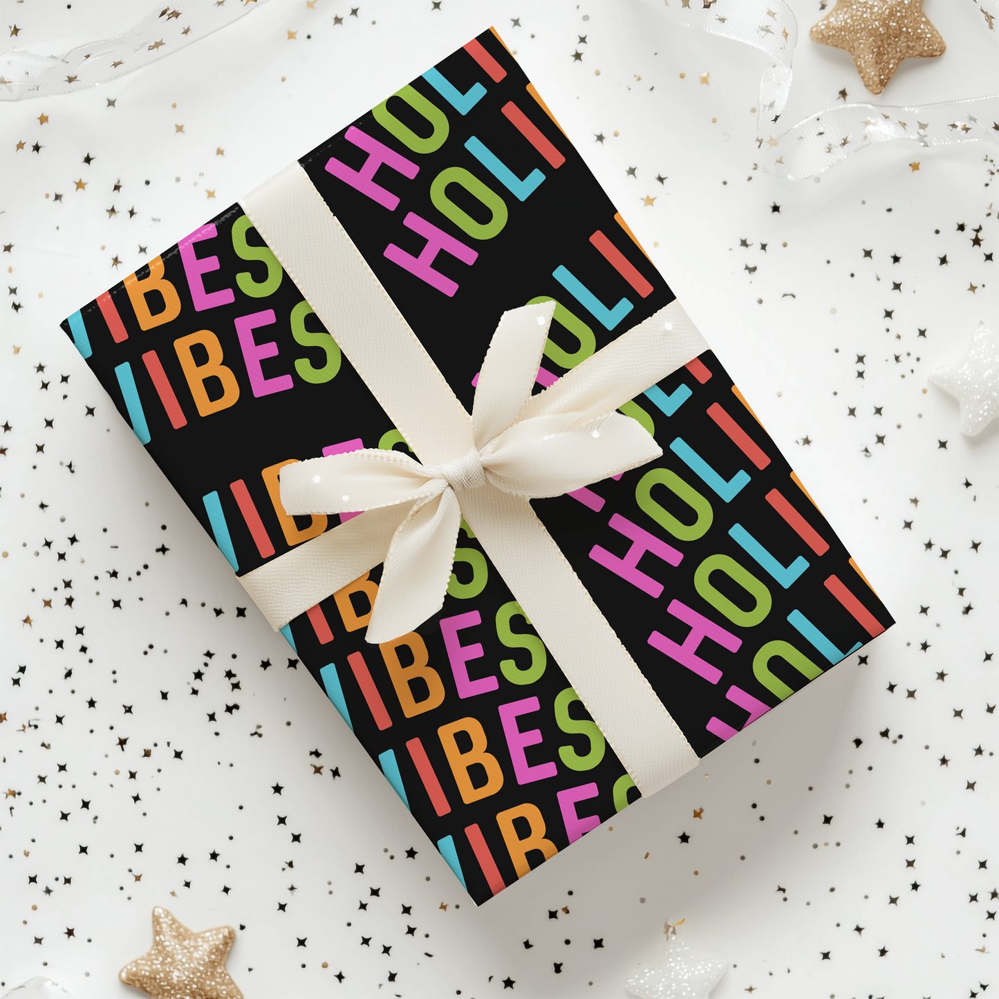 a gift wrapped in a colorful wrapping paper with a white ribbon