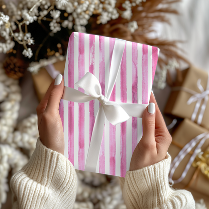 a woman holding a pink and white gift box