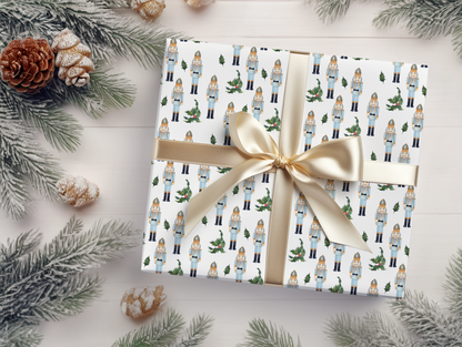 a present wrapped in white paper with a gold bow