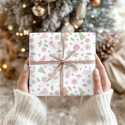 a person holding a present in front of a christmas tree