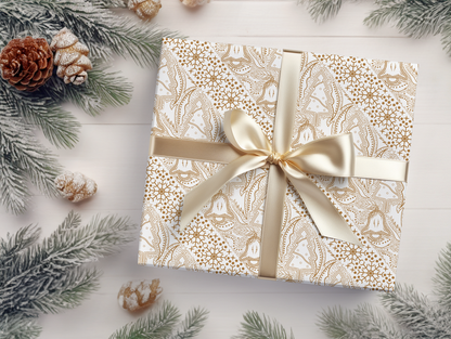a gift wrapped in a white and gold paper with a gold bow