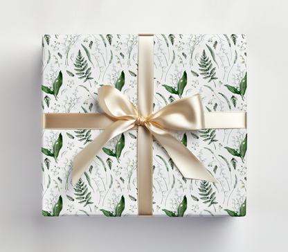 a wrapped gift box with a gold ribbon