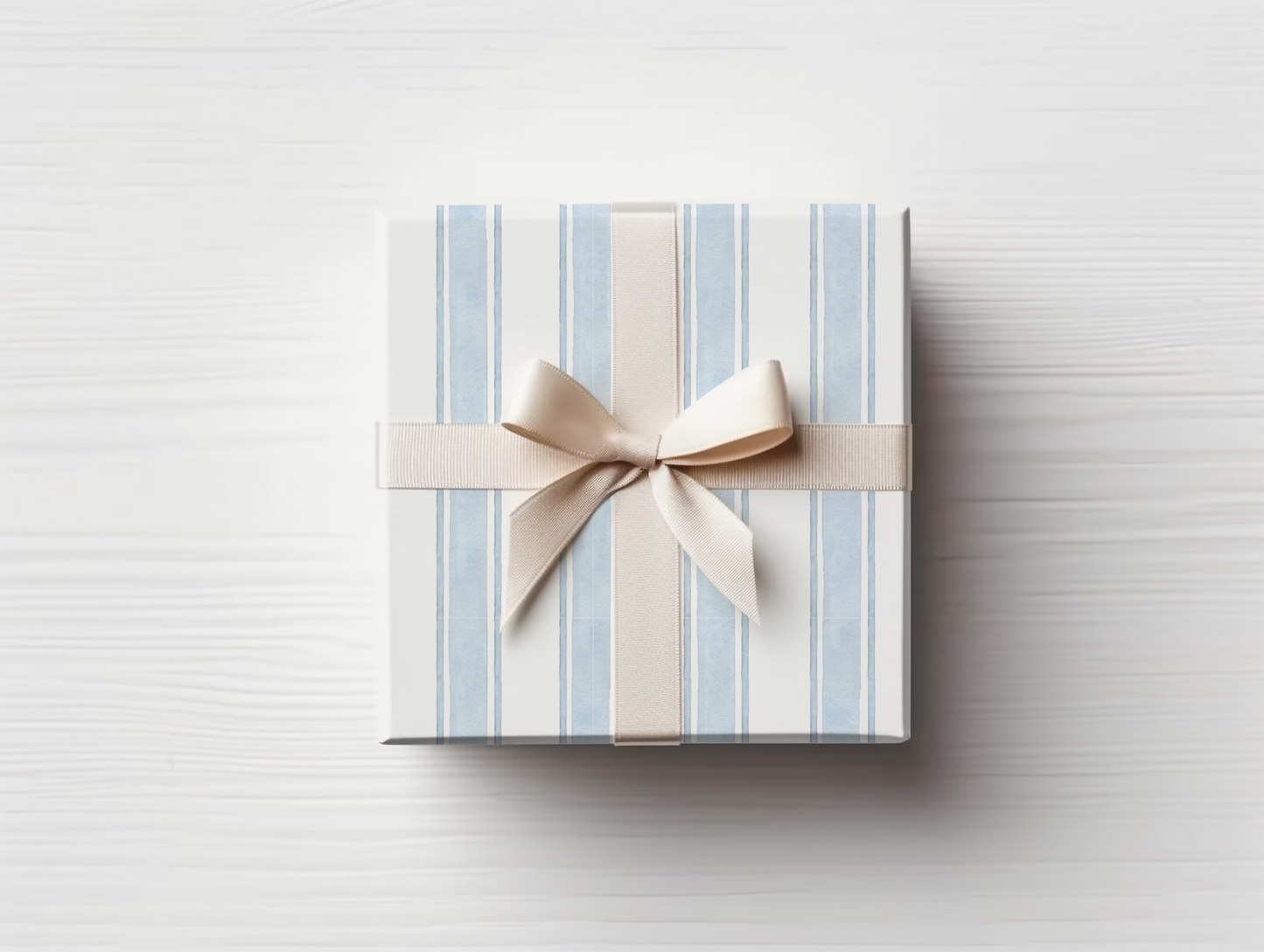 a blue and white striped gift box with a bow