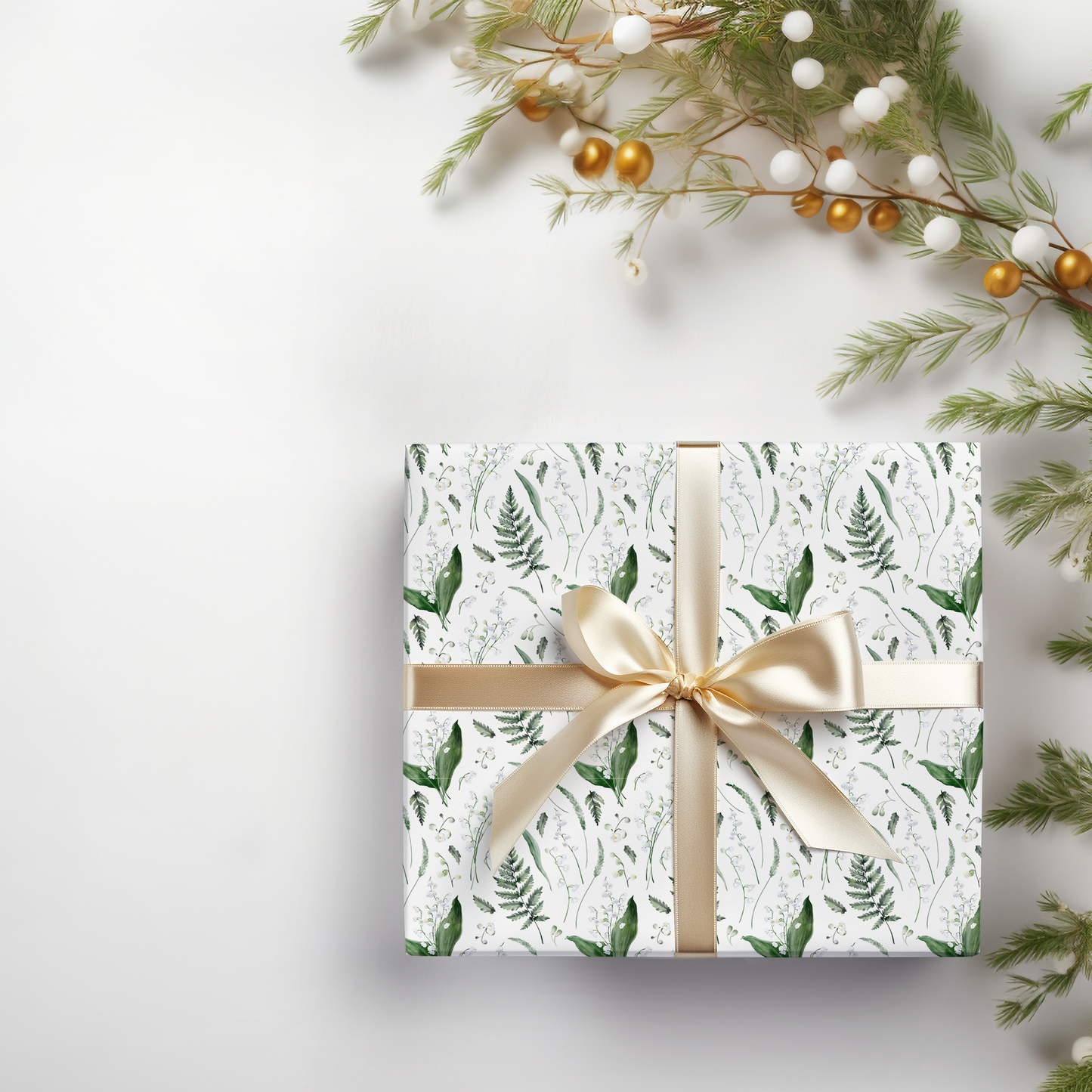 a present wrapped in white paper with a gold bow