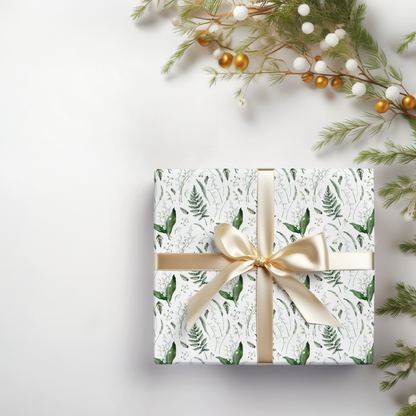 a present wrapped in white paper with a gold bow